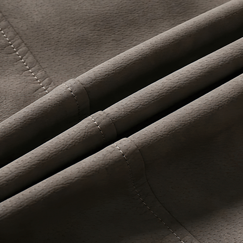 Close-up of soft PU leather fabric showcasing elegant texture and stitching for men's biker jackets.