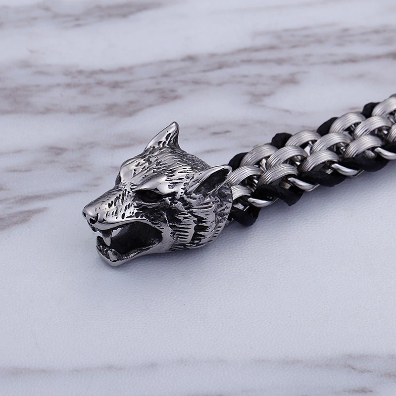 Vintage men's stainless steel bracelet with detailed wolf head design on a braided cowhide leather band.