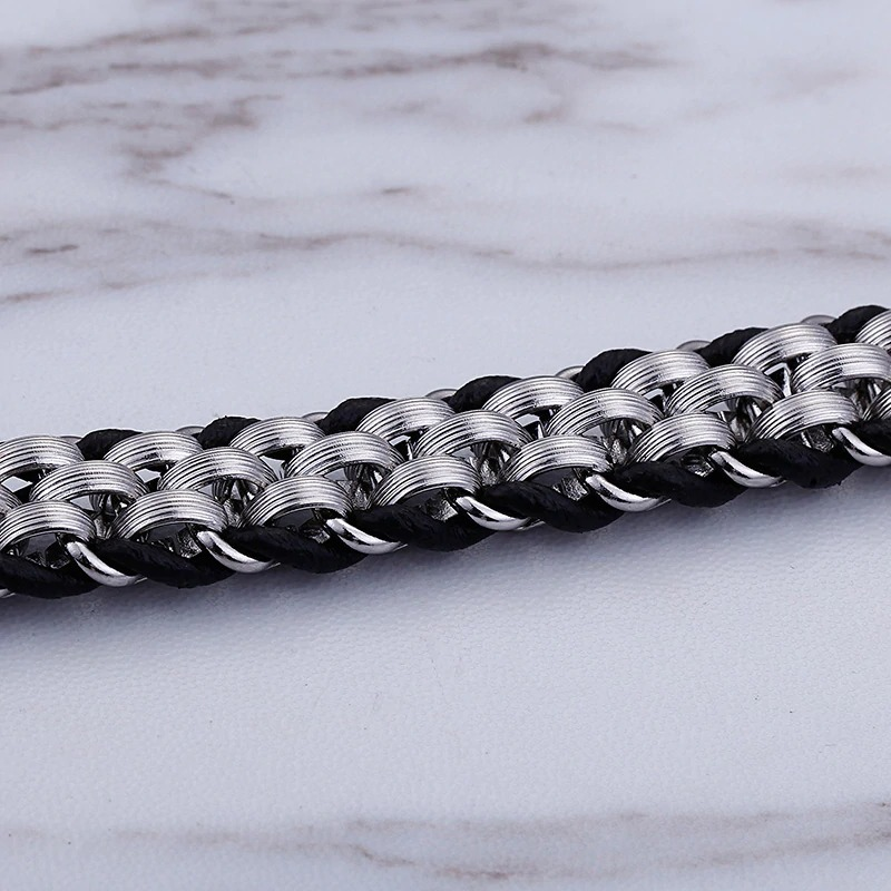 Vintage men's stainless steel and cowhide leather bracelet showcasing unique weave and wolf head detail.