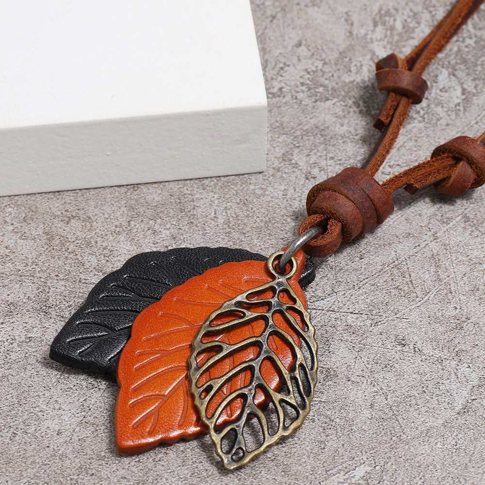 Vintage leather necklace with leaf pendants in brown and orange, showcasing punk style jewelry.