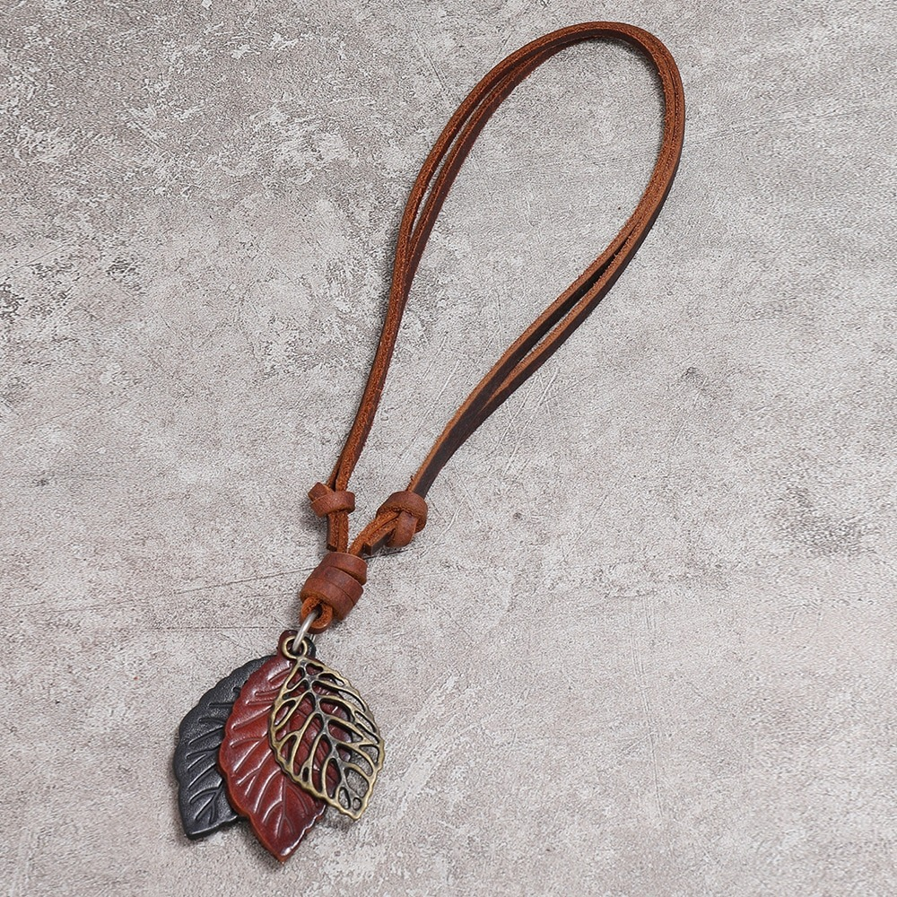 Vintage leather necklace with leaf pendants in brown and silver for a stylish punk look.