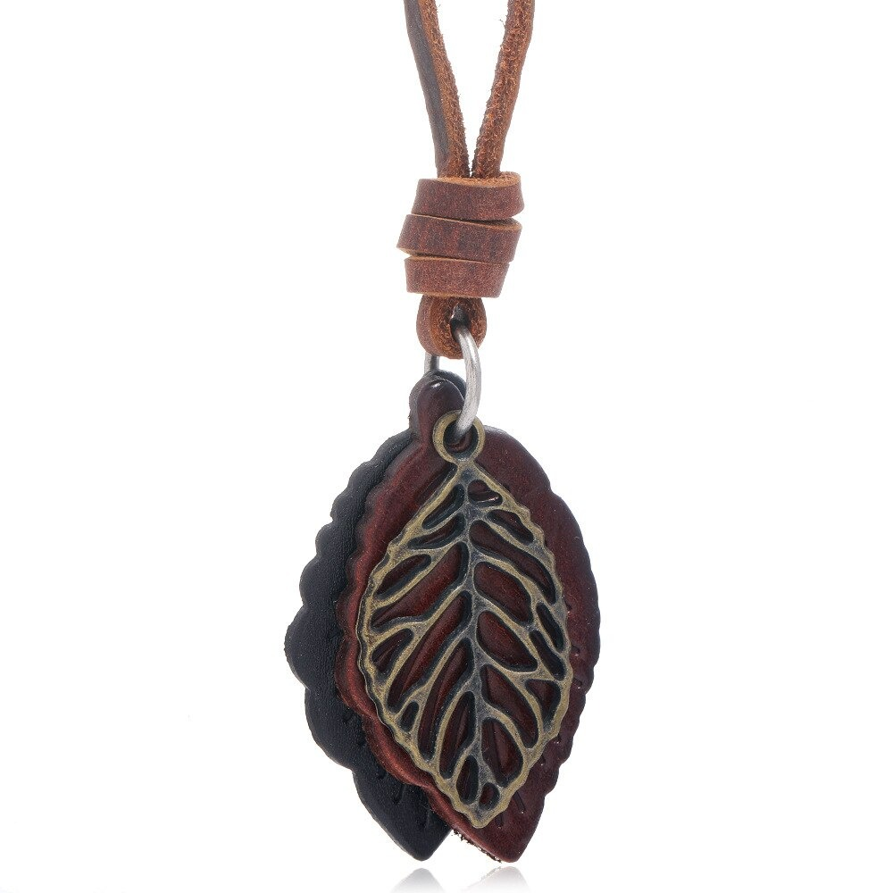 Vintage leather necklace pendant shaped like a tree leaf, featuring brown leather and an antique-style metal leaf design.