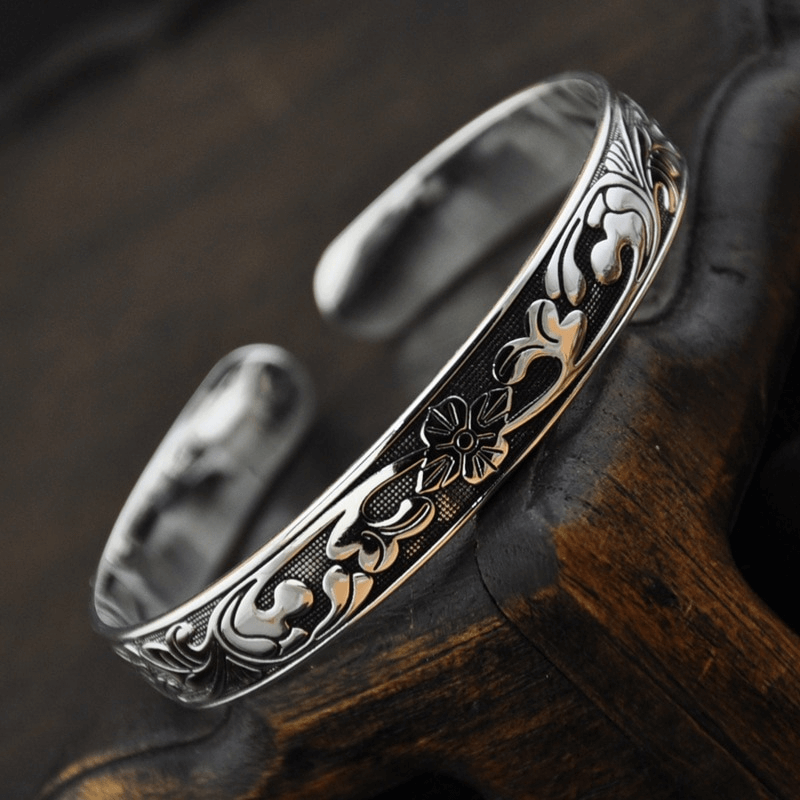 Vintage silver metal bangle bracelet featuring an ethnic floral pattern, perfect for women's stylish accessories.