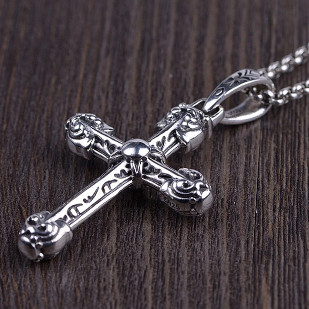 Detailed vintage sterling silver gothic cross pendant on a wooden background, perfect for men and women.