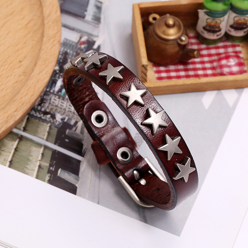 Vintage PU leather bracelet flaunting silver stars, perfect punk-rock unisex accessory for trendy outfits.