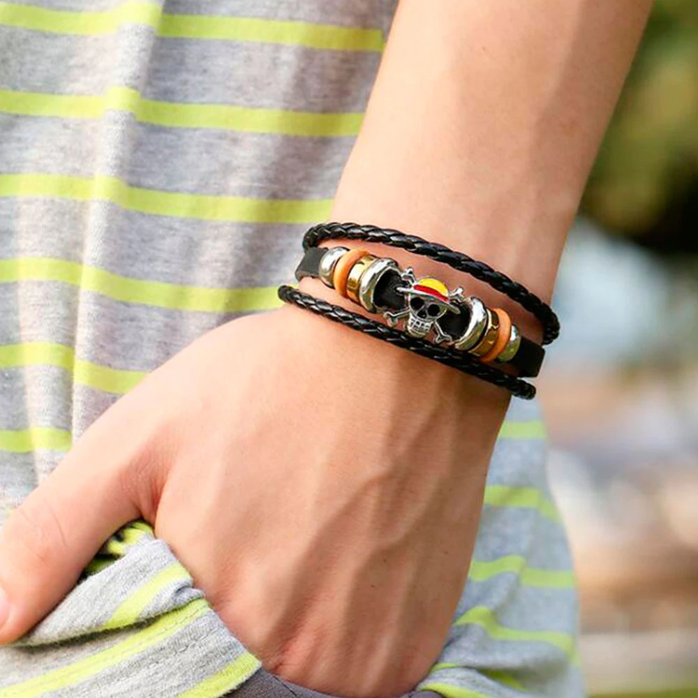 Stylish vintage PU leather bracelet with skull charm and colorful beads worn on hand, showcasing punk fashion.