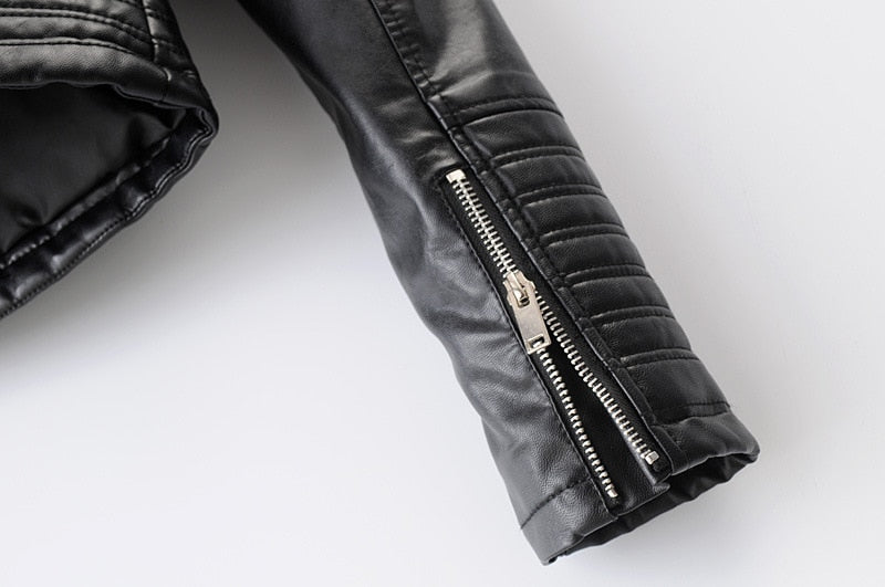 Close-up of the zippered sleeve detail on a women's vintage faux leather motorcycle jacket.