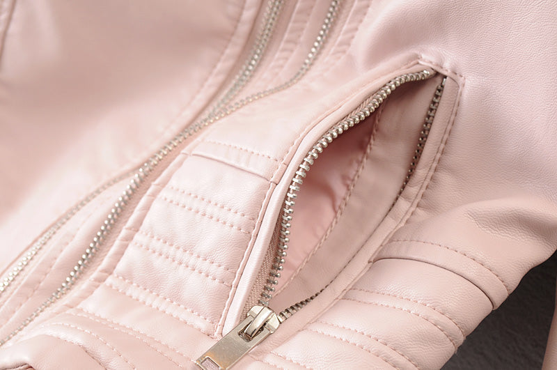 Close-up of a vintage faux leather motorcycle jacket pocket featuring stylish zippers and soft lining, perfect for chic biker looks.