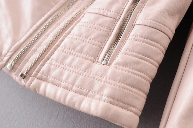 Close-up of vintage PU leather motorcycle jacket showcasing stylish zippers and quilted detailing for a chic biker look.
