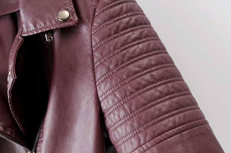 Close-up of a women's vintage PU leather motorcycle jacket featuring stylish quilted shoulder detail.