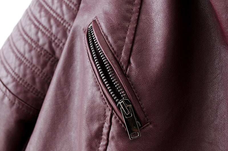 Close-up of vintage PU leather motorcycle jacket showing stylish zipper and rich burgundy color for women's biker fashion.