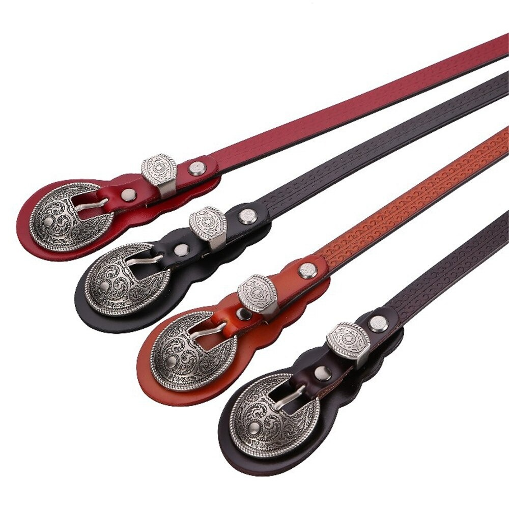 A collection of vintage real leather belts with ornate silver buckles in four stylish colors: red, brown, black, and maroon.