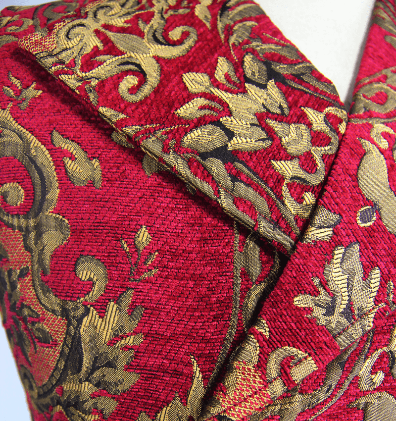 Close-up of a vintage red waistcoat with gold filigree patterns and stylish buttons for men.
