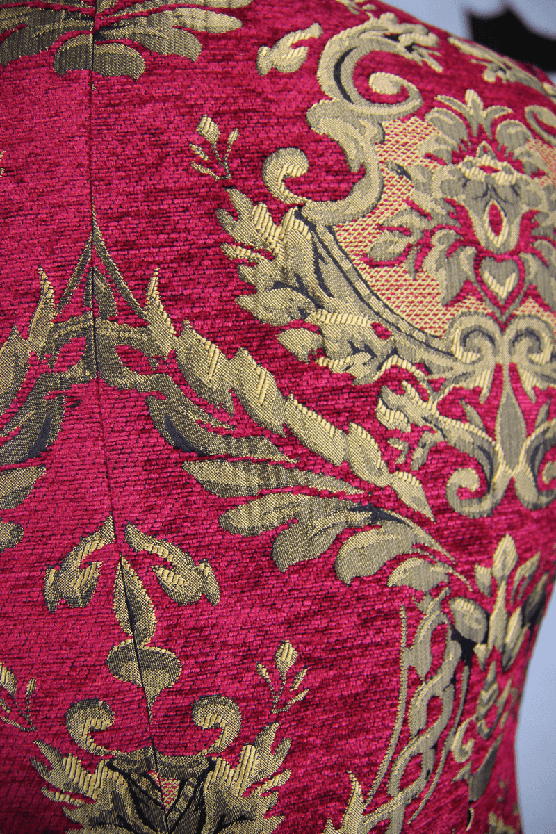 Close-up of the intricate gold filigree pattern on a vintage red waistcoat for men, showcasing gothic luxury design.