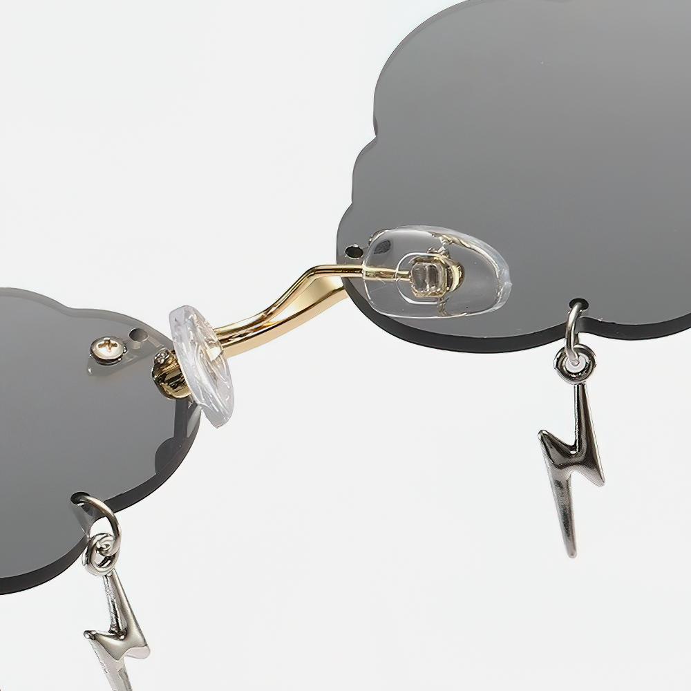 Vintage rimless cloud sunglasses featuring lightning decor, unisex alternative style accessory close-up.
