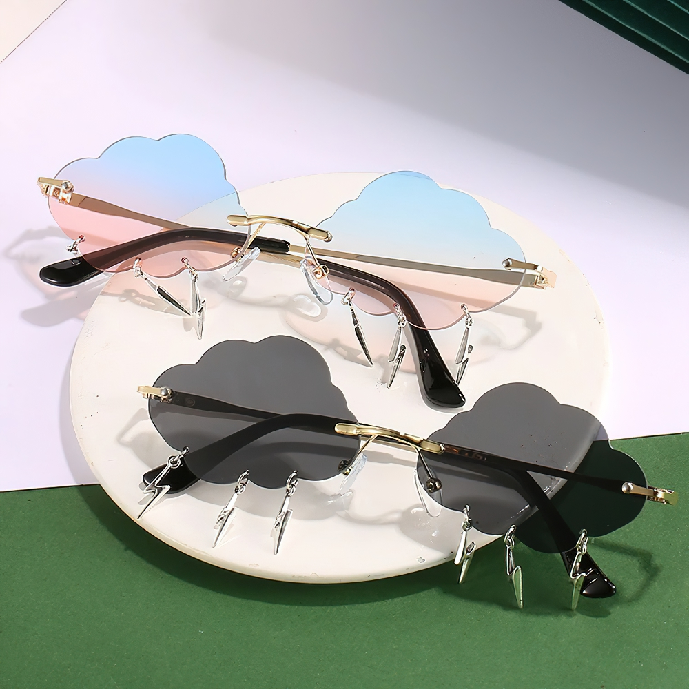Vintage rimless cloud sunglasses in blue and black with lightning accents, trendy unisex accessory on display.
