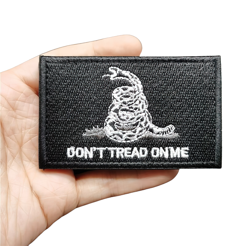 Unisex embroidered patch featuring a snake and 'Don't Tread On Me' text on a black background for stylish clothing.