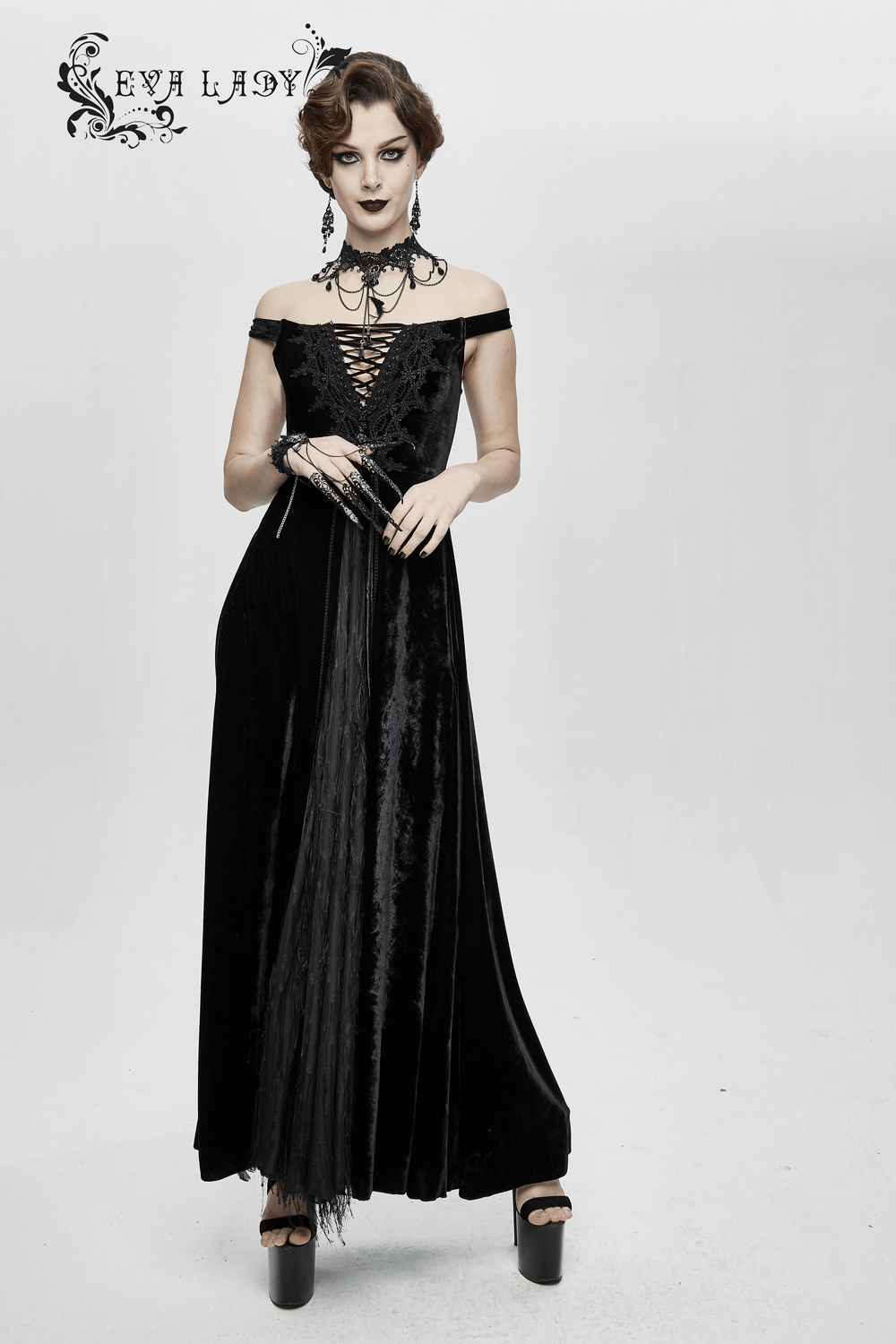 Elegant gothic black off shoulder velvet long dress with lace, showcasing a stunning model and dramatic style.