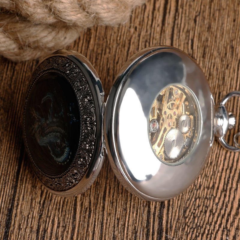 Vintage silver mechanical pocket watch showcasing intricate dragon design and elegant craftsmanship.