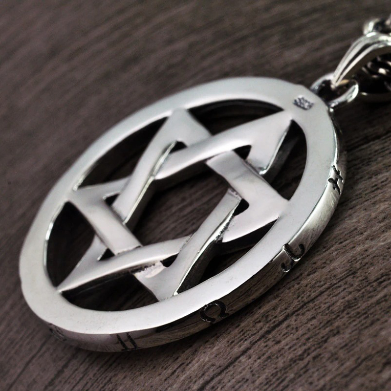 Vintage silver pendant in the form of a hexagram, showcasing intricate design and unique style for fashion enthusiasts.