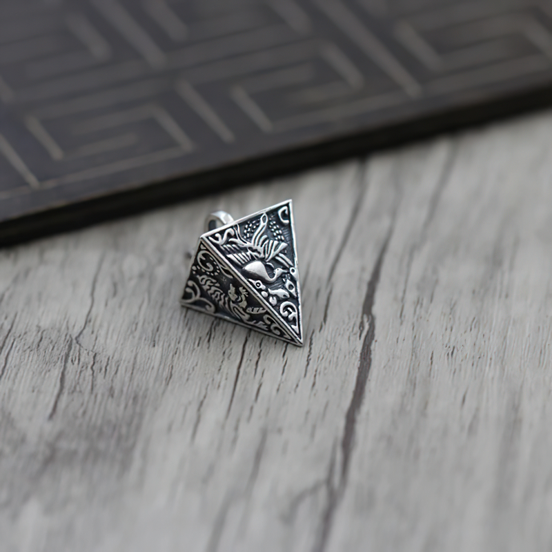 Vintage silver pyramid pendant featuring intricate animal designs, perfect for stylish outfits and gifts.