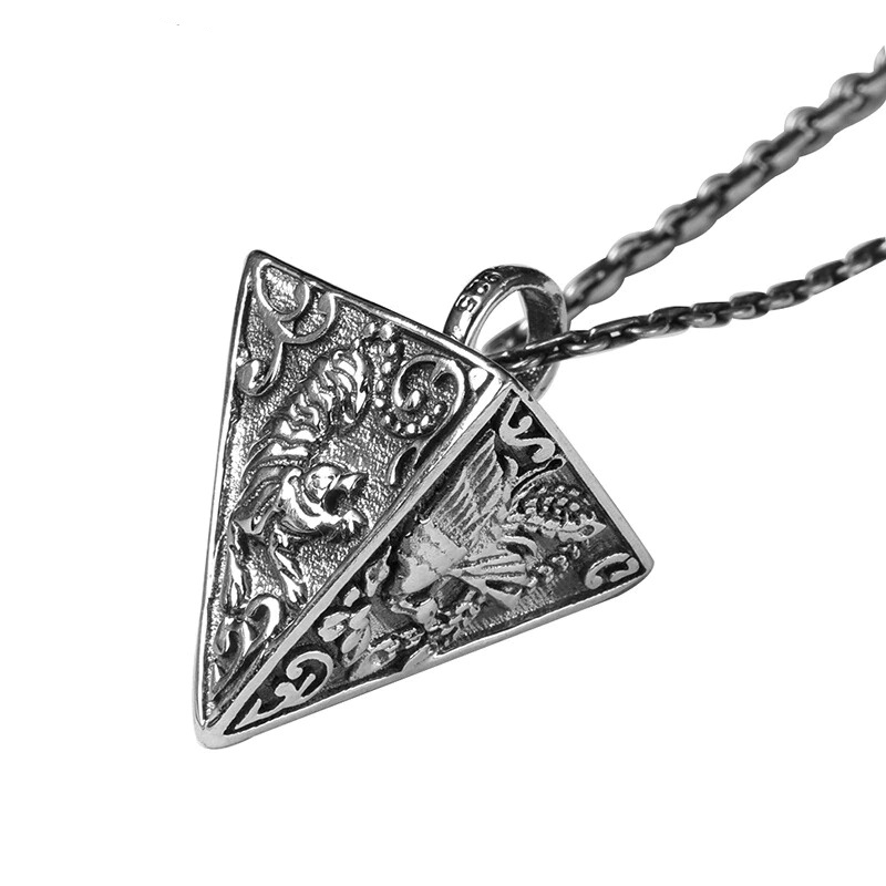 Vintage silver pyramid pendant featuring intricate animal designs, perfect for stylish jewelry lovers.