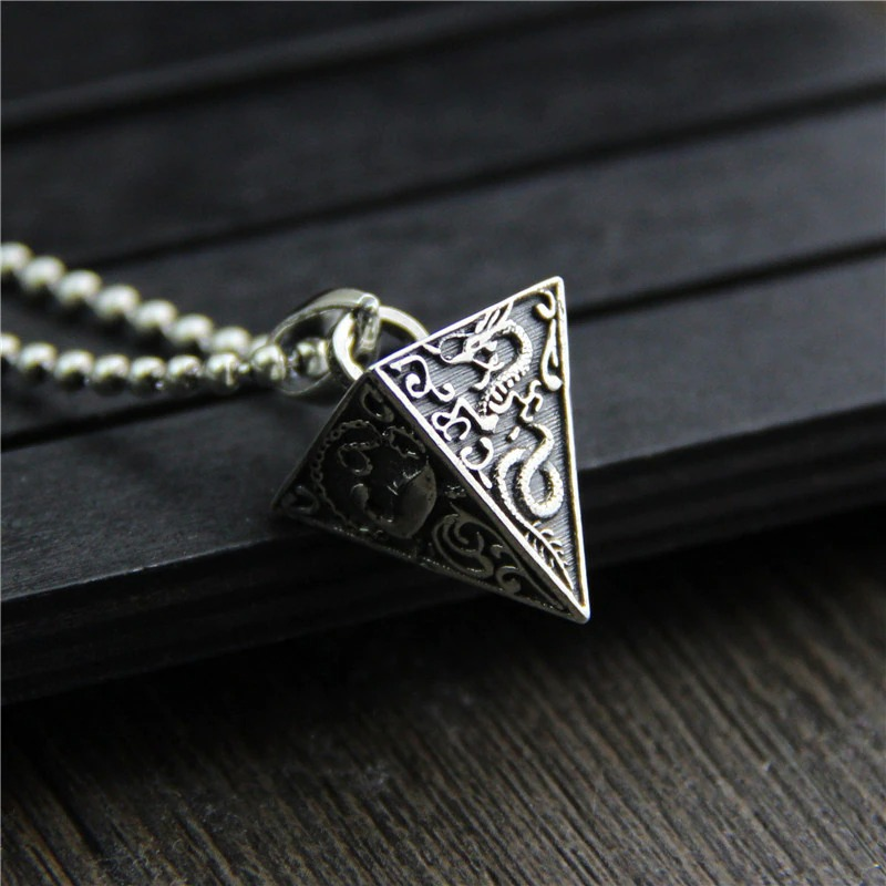 Vintage silver pyramid pendant necklace featuring intricate animal designs, perfect for adding style to your outfit.
