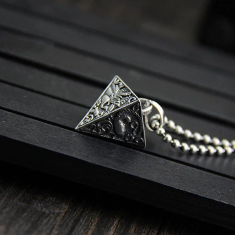 Vintage Thai silver pyramid pendant necklace with intricate animal designs, perfect for stylish outfits and gifts.