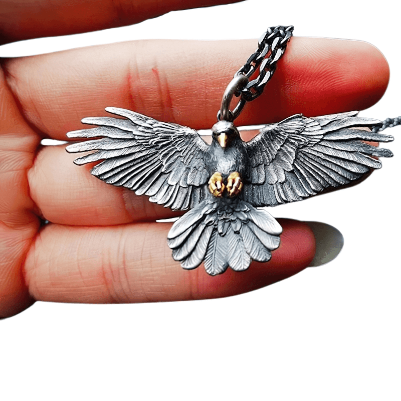 Vintage silver plated crow pendant necklace held in hand, showcasing intricate punk design for unisex fashion.
