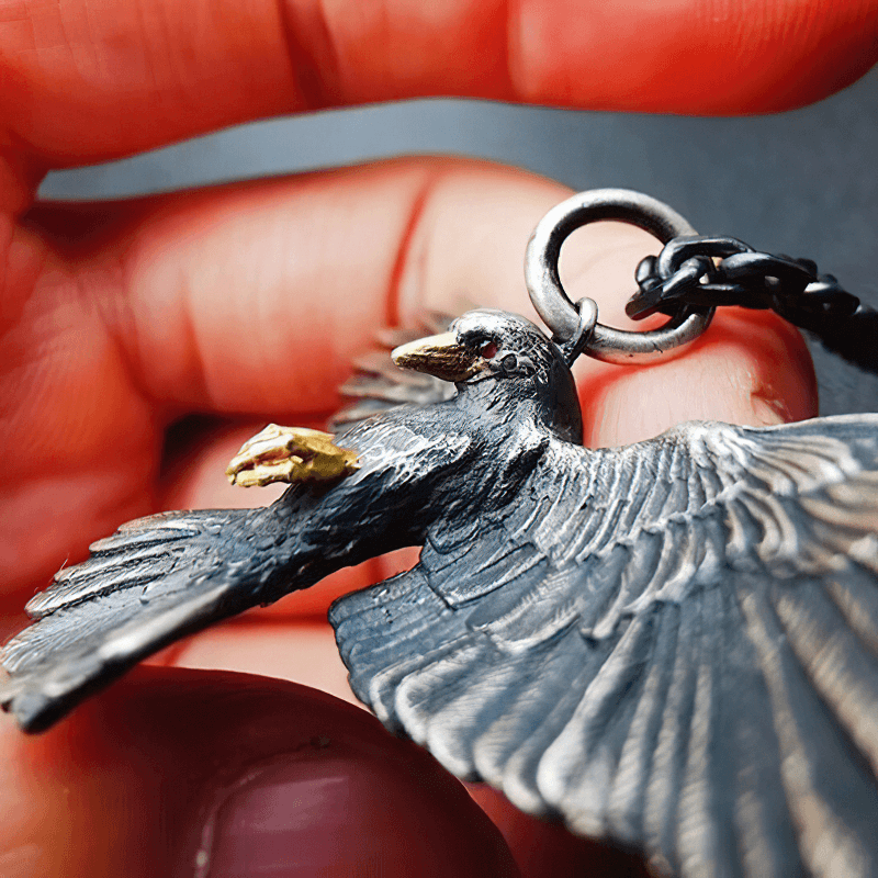 Vintage silver plated crow pendant held in hand, showcasing intricate details and punk style.