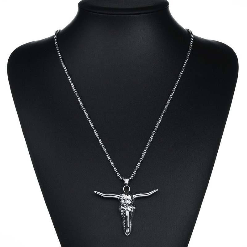 Vintage stainless steel bull head pendant necklace highlighting alternative fashion jewelry style.