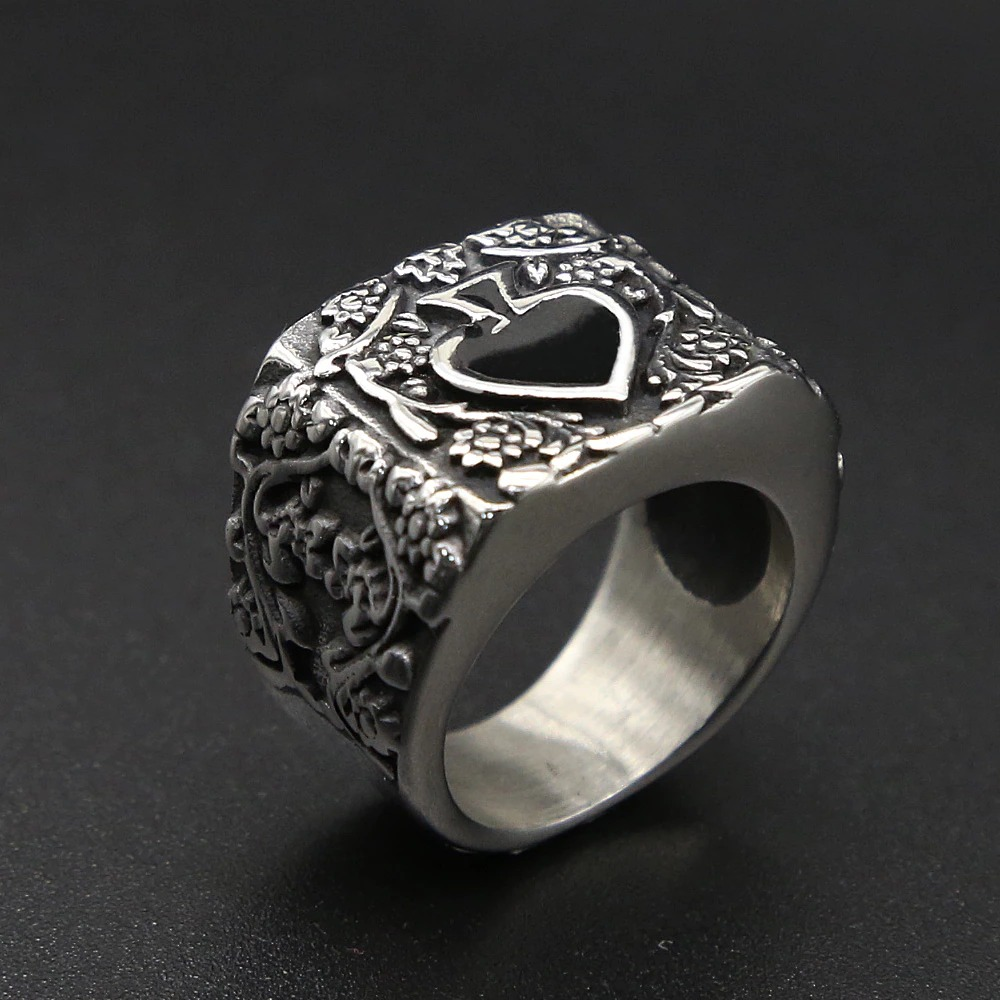 Vintage stainless steel ring with floral design and heart, perfect for rock-style outfits.