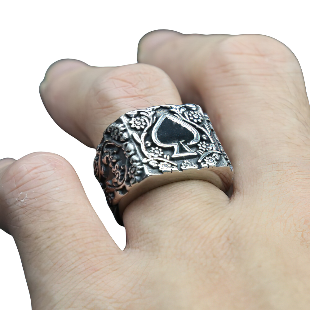 Stainless steel men's ring with spade design, showcasing vintage rock style on a hand.