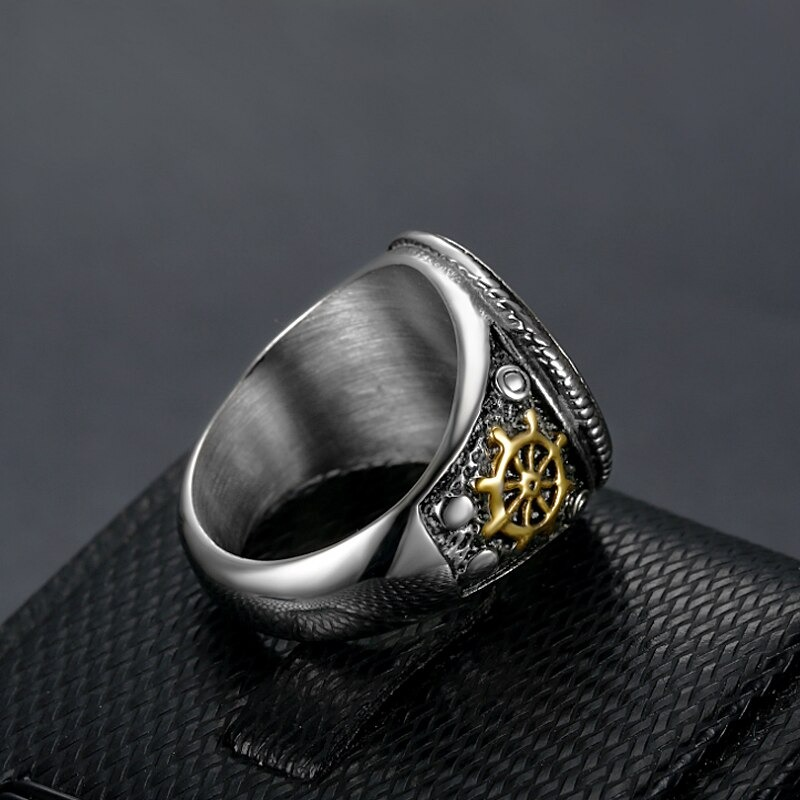 Vintage stainless steel pirate skull ring with golden wheel design, perfect punk accessory for stylish outfits.