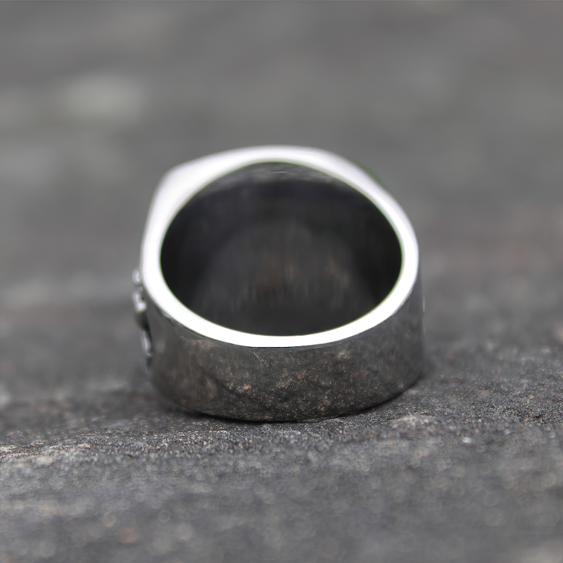 Close-up of a vintage stainless steel Masonic ring featuring a sleek interior and detailed exterior design.