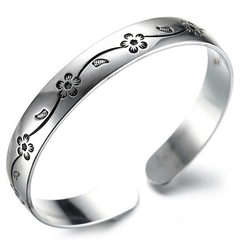 Vintage silver plated bangle bracelet with elegant blossom pattern for men and women, stylish metal jewelry.