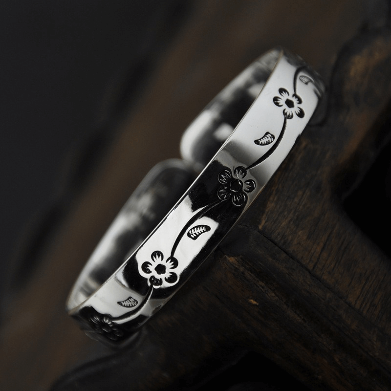 Vintage silver plated bangle bracelet with elegant blossom pattern, perfect unisex accessory for any outfit.