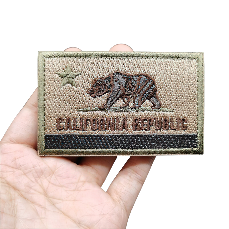 California Republic military patch featuring bear design in hand, stylish khaki accessory for clothing.