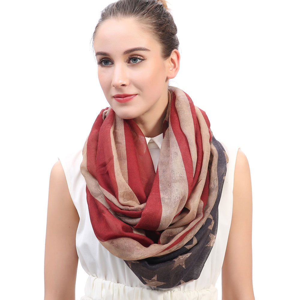 Woman wearing a Vintage USA Flag infinity loop scarf, showcasing its trendy red, white, and blue star stripe design.