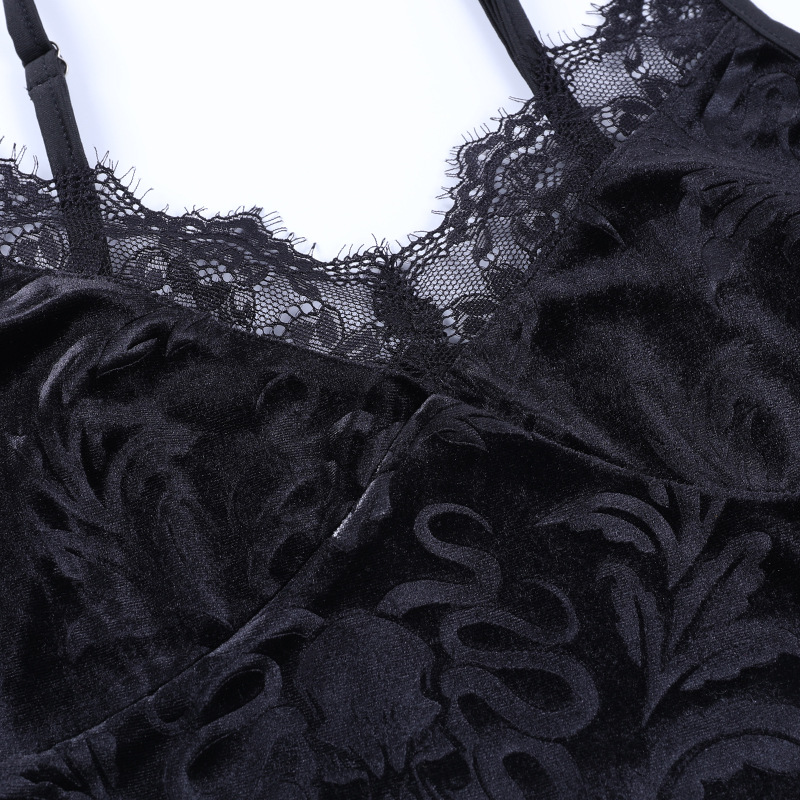 Close-up of vintage black velvet women's top with lace trim, showcasing gothic style and luxurious detail.