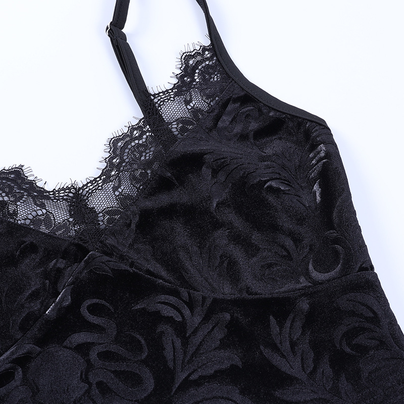 Close-up of vintage black velvet women's crop top with elegant lace trim detailing.