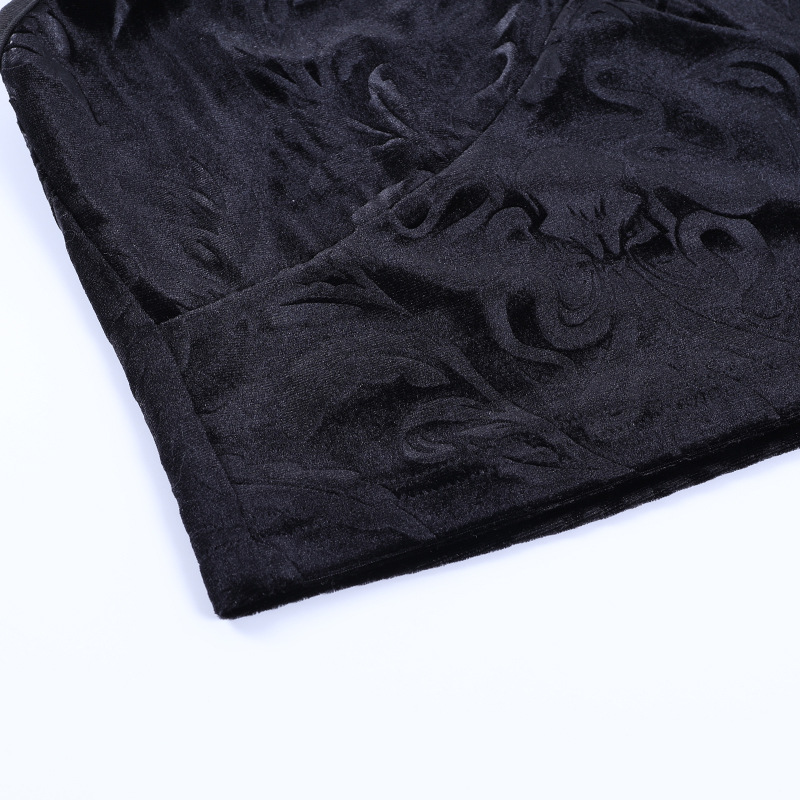 Close-up of vintage black velvet fabric with elegant embossed design, perfect for gothic fashion.