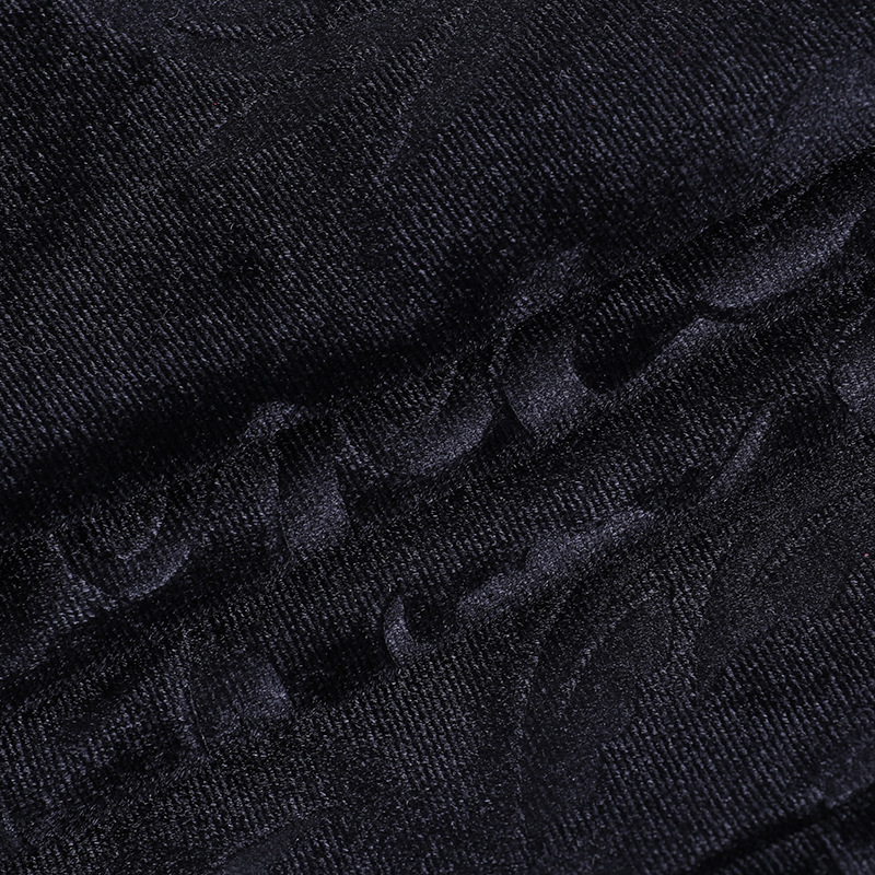 Close-up of vintage velvet black fabric with intricate patterns for gothic women's top.