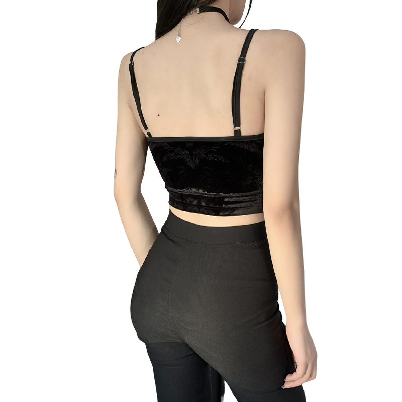 Back view of a vintage black velvet women's crop top with straps, showcasing gothic style.