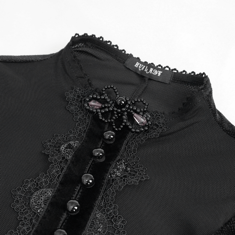 Close-up of the black velvet dress collar featuring lace applique and beaded embellishments.