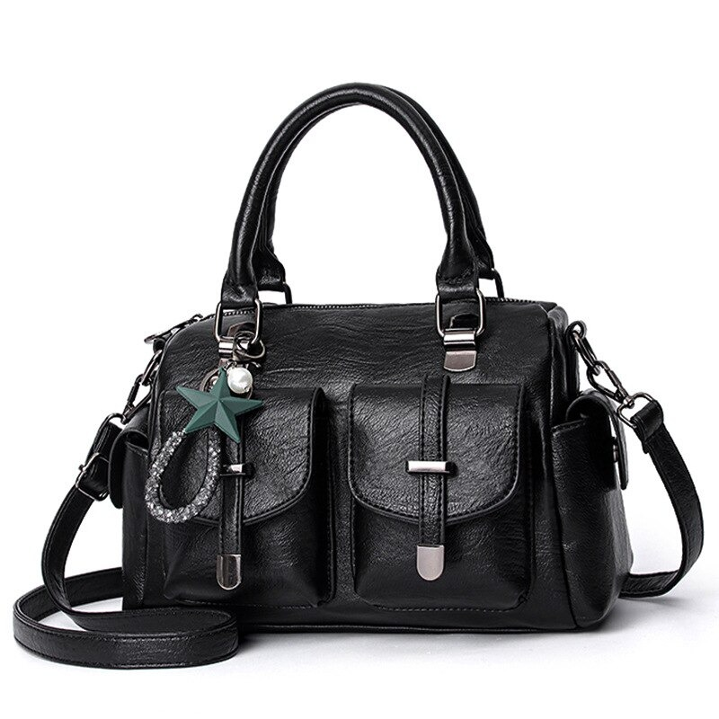 Vintage women's black leather handbag with star pendant and multi-pocket design, stylish soft shoulder bag.