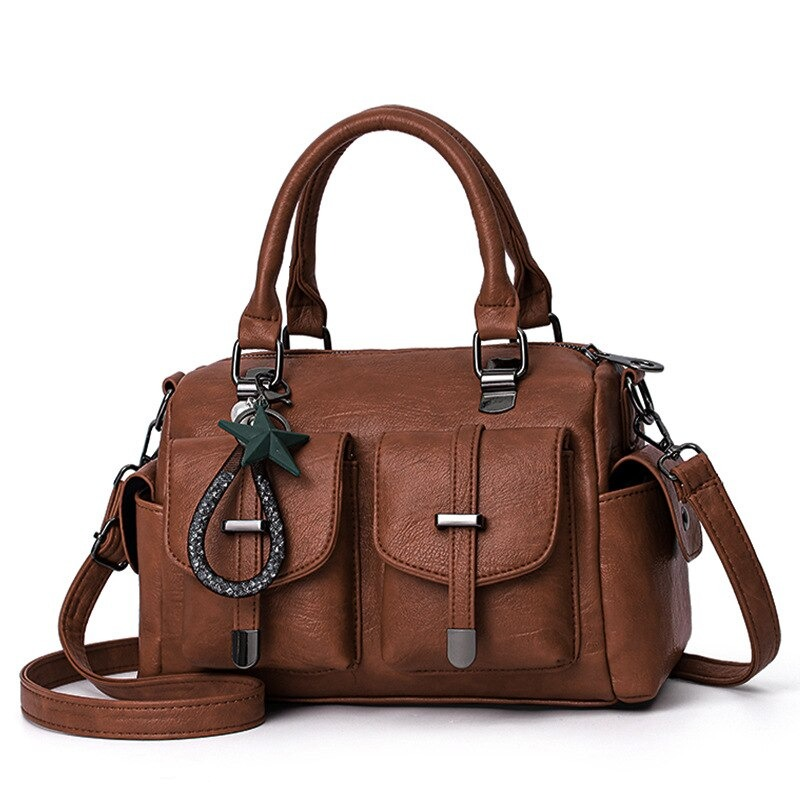 Vintage women handbag with star pendant, soft leather shoulder bag, stylish multi-pocket design in brown.