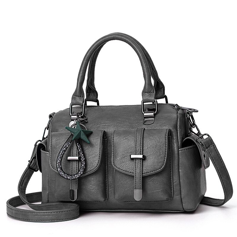 Vintage women's handbag in grey soft leather with star pendant, designed for style and functionality.