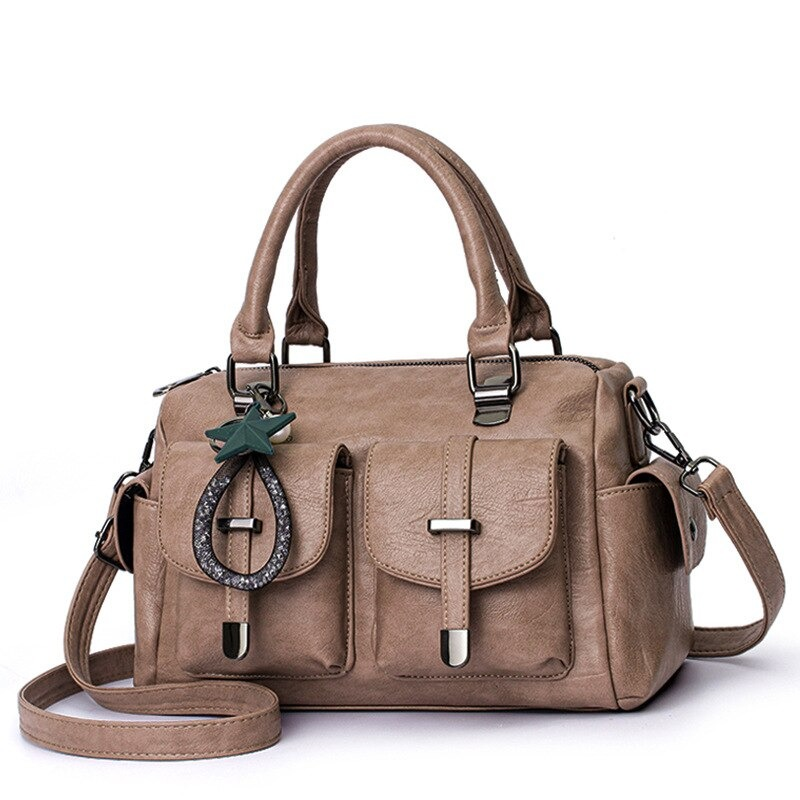 Vintage women's soft leather handbag with star pendant, multi-pocket design in taupe.