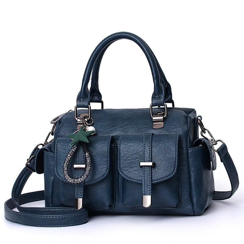 Vintage women's handbag in blue soft leather with star pendant and multiple pockets.